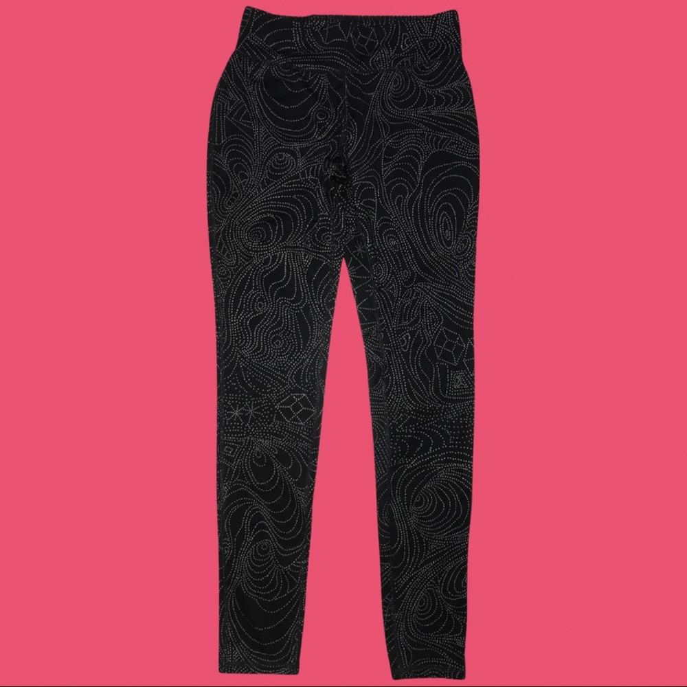Black athletic leggings with a rad pattern throughout.